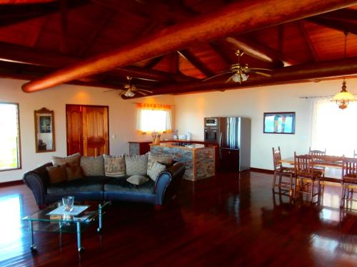 a living room with a couch and a table at Korovesi Sunshine Villas in Savusavu