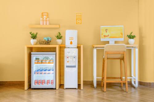 a room with two refrigerators and a desk with a computer at Bloom Hotel Katra in Katra