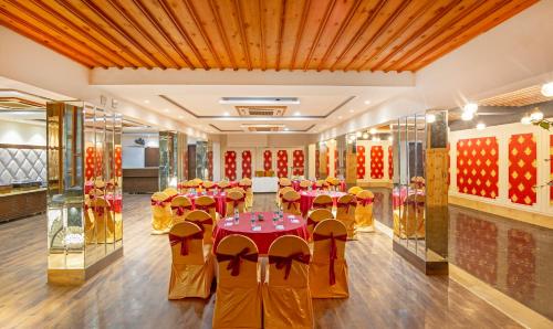 a banquet hall with tables and chairs in a room at Treebo JD Residency Mohali in Chandīgarh