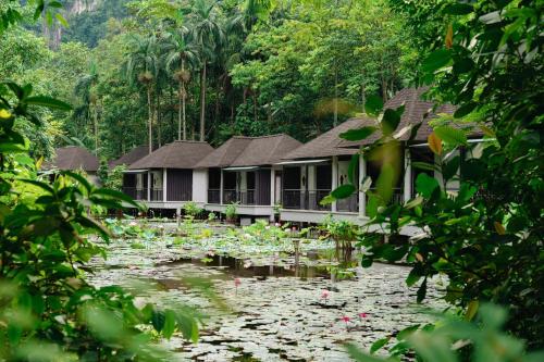 a house in the middle of a pond with lilies at The Banjaran Hotsprings Retreat in Ipoh