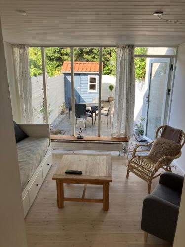 a living room with a couch and a coffee table at Nyrenoveret charmerende byhus in Assens