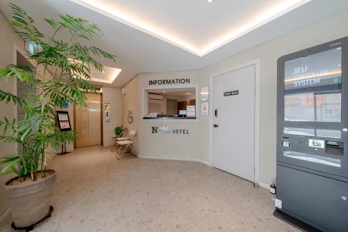 an office hallway with a door and a plant at No25 Hotel Jeonju Sanjeong in Jeonju