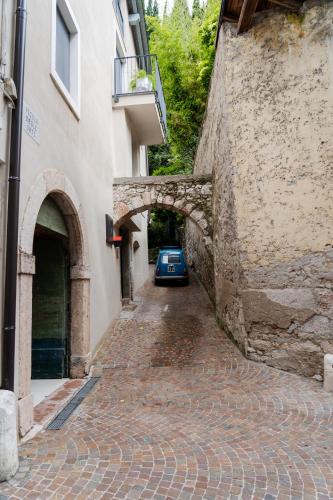 a car parked under an archway on a brick street at Casaorti Olio Design in Arco
