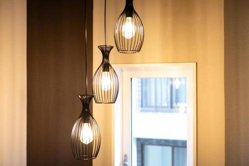 a group of lights hanging from a wall at S9W13 LABOINN Large private house in Sapporo
