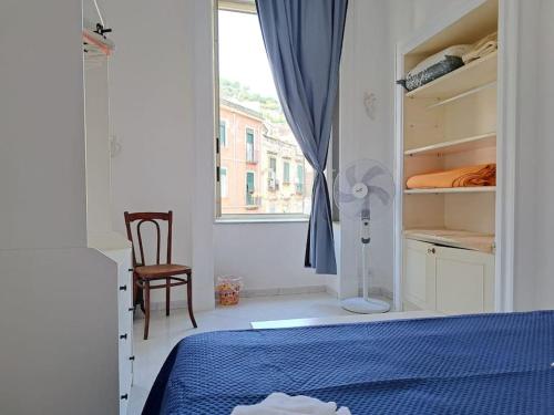 a bedroom with a bed and a window and a chair at Appartamento Cuore di Napoli 2 in Naples