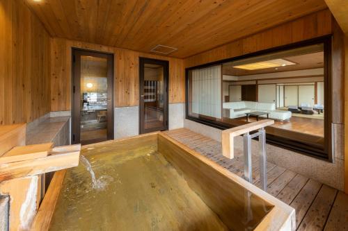 a pool of water in a room with wooden walls at Kinugawa Hotel Mikazuki in Nikko