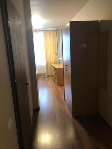 a hallway with a door to a room with a table at RVR Smart Apartments Riga with Free Parking and Self Check-in in Rīga