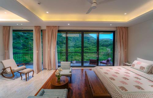 a bedroom with a bed and a large window at Artisav House-A Luxury Boutique Stay in Jaipur