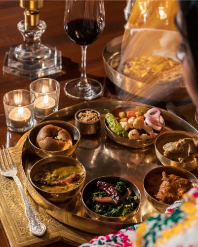 a tray filled with different types of food on a table at DESERT OVERNIGHT LUXURY CAMP & ReSORT in Jaisalmer