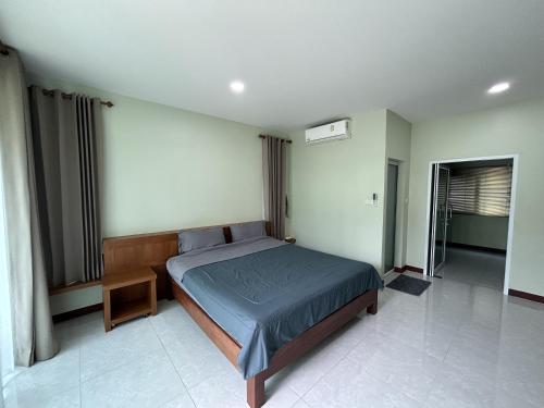 a bedroom with a large bed in a room at Mina House in Baan Tai