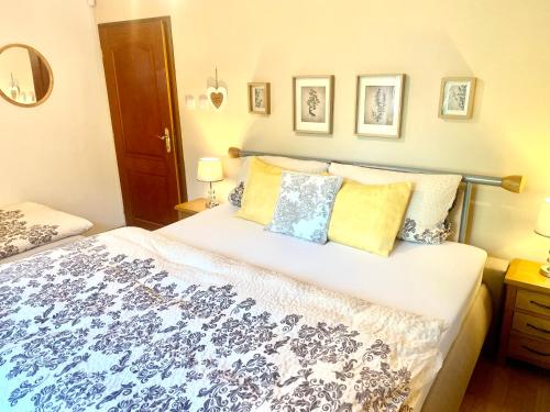 a bedroom with a large bed with blue and white sheets at Vila EVIO Třeboň in Třeboň