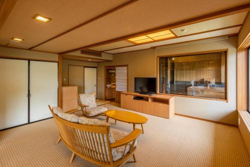 a living room with a couch and a table at Kinugawa Hotel Mikazuki in Nikko