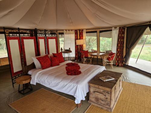 a bedroom with a large bed in a tent at Dolly Farm & River Camp, Luxury Tents in Usa River