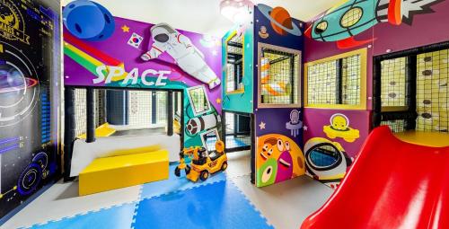 a kids play room with a slide at Daebudo sunshine kids poolvilla in Ansan