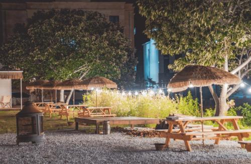 a group of picnic tables with straw umbrellas at Yangyang Staydaro in Yangyang