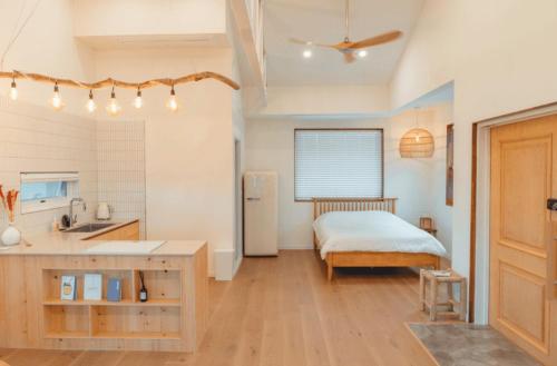 a kitchen with a sink and a bed in a room at Yangyang Staydaro in Yangyang