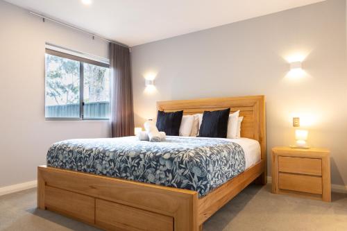 a bedroom with a large bed with a teddy bear on it at Park View in Margaret River Town