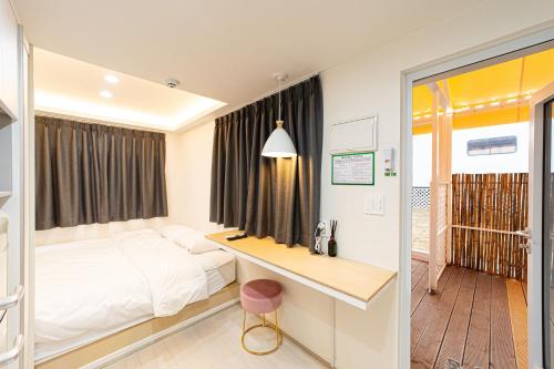 a hotel room with a bed and a desk at Chuncheon Weolsongli Camp in Chuncheon
