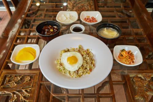 a plate of food with an egg on a table at Chuncheon Weolsongli Camp in Chuncheon