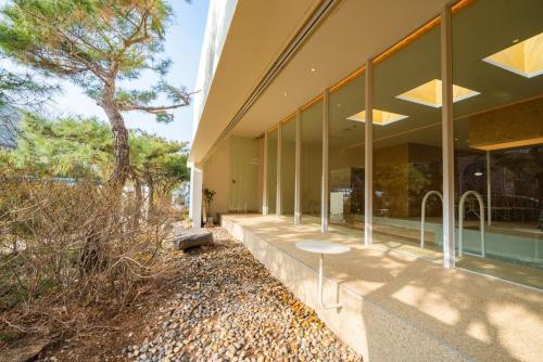 an exterior view of a building with a tree at Daebudo Space Pool Villa in Ansan