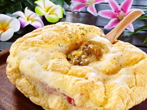 a pie sitting on a table with a wooden spoon in it at Ma-Blue Garden House in Motobu