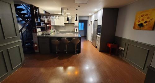 a kitchen with a table and chairs in a room at Yangpyeong Antonio Pension in Yangpyeong