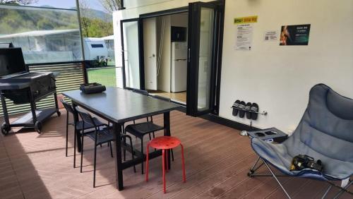 a room with a table and chairs and a piano at Pocheon Lodge Caravan Camping Site in Pocheon