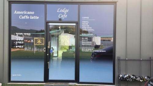 an open glass door of a golf club at Pocheon Lodge Caravan Camping Site in Pocheon