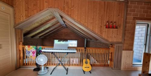 a room with a piano and a guitar in a house at Bauhaus In Wonju in Wonju