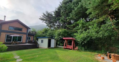 a house with a yard with a gazebo at Bauhaus In Wonju in Wonju