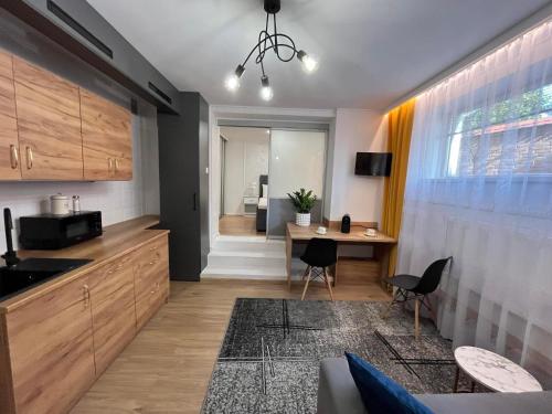 a kitchen with a table and chairs in a room at Apartament Lena in Przemyśl