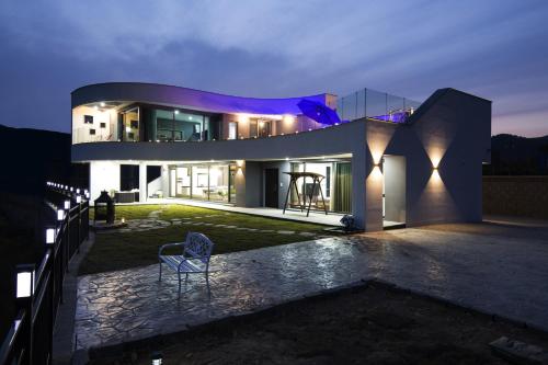 a house at night with a chair in the yard at Goseong Essay The in Goseong