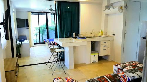 a kitchen with a counter and a sink in a room at Penthouse Crystal Bay Apartments in Ban Lamai