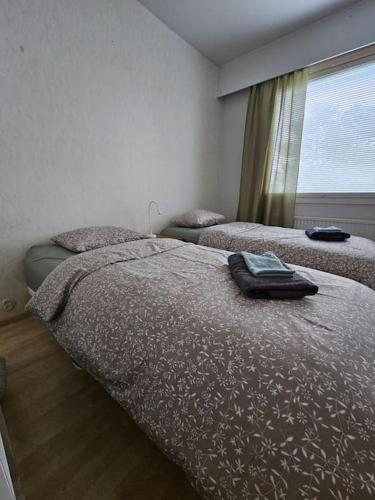 a bedroom with two beds and a window at Satakieli - 2 bedroom apartment incl free parking and wifi max 5 person in Harjavalta