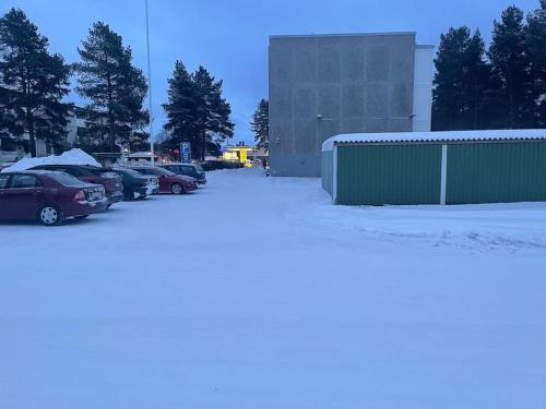 a parking lot with cars parked in the snow at Satakieli - 2 bedroom apartment incl free parking and wifi max 5 person in Harjavalta
