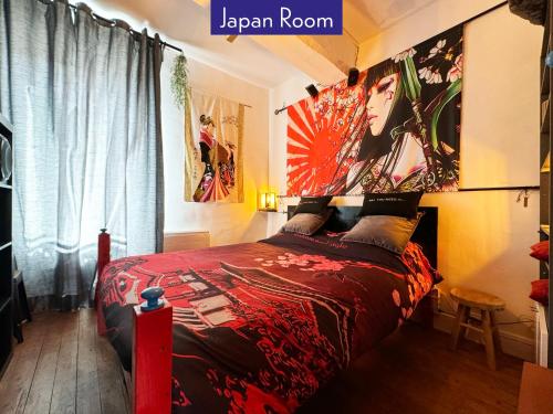 Un dormitorio con una cama grande con una colcha roja. en Appartements Studio et Japan Room - Proche Disneyland Paris, en Crécy-la-Chapelle
