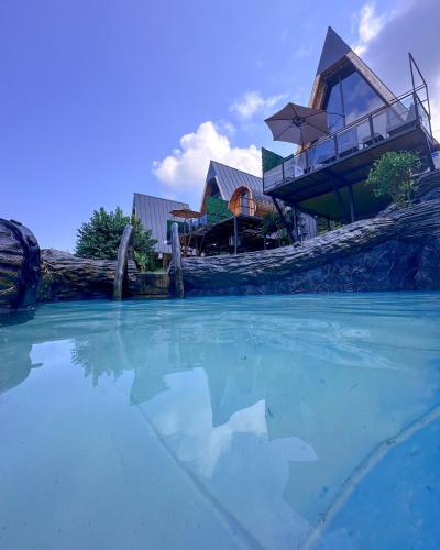 a house on a hill with a pool of water at Turo House in Batumi
