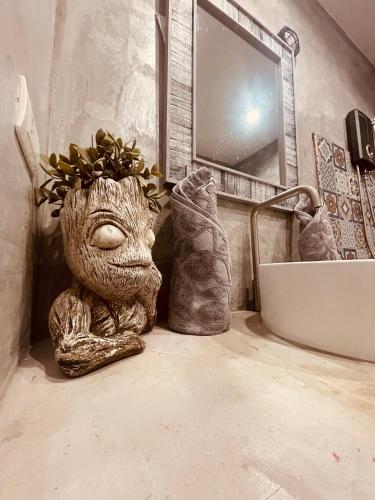 a statue of a creature sitting in a bathroom at Destination39 in Thalang