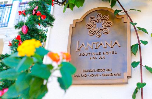a sign on the side of a building at Lantana Boutique Hoi An Hotel in Hoi An