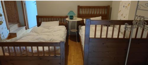 a bedroom with two bunk beds and a table with a lamp at Lesse en Ciel vous accueille avec plaisir . in Houyet