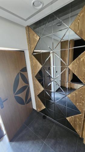 a glass wall in a room with a door at Porębiańska Osada Resort & Spa in Szlembark