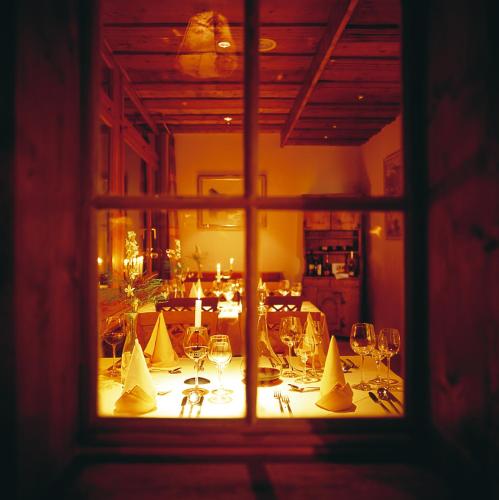 a room with a table with wine glasses and candles at Hotel Rovanada Wellness & BergNatur in Vals