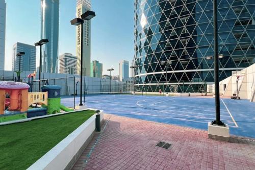 a tennis court in the middle of a city at DIFC Luxury 1-Bed Apt with Stunning City Views in Dubai