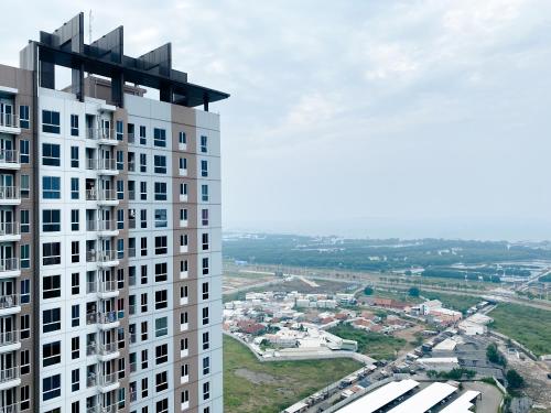 an aerial view of a tall building at Restful and Good Deal Studio at Tokyo Riverside PIK 2 Apartment By Travelio in Rawalembang