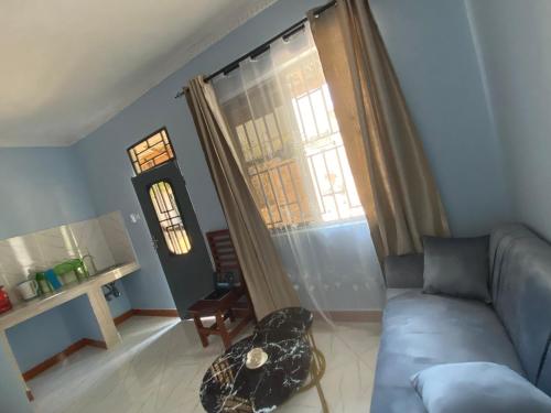 a living room with a couch and a window at COMFORT HAVEN Studio in Ilemera