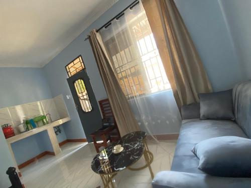 a living room with a couch and a window at COMFORT HAVEN Studio in Ilemera