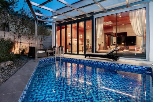a swimming pool in the backyard of a house at Jincheon Walking the Memory 2 Pension in Jincheon