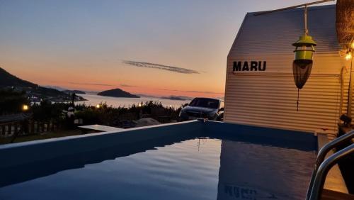 a pool in front of a garage with a sunset at Yeosu Maru Pension in Wŏnp'o