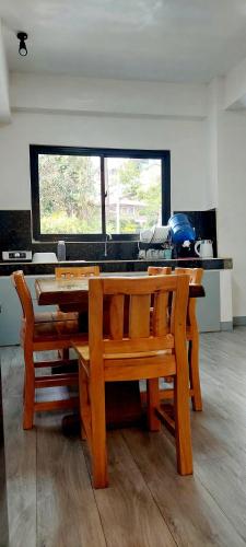 a wooden table and bench in a kitchen with a window at 4BR Entire Floor - 2 Adjacent Units, 2BR Each Unit, with Balconies and Mountain View in Baguio
