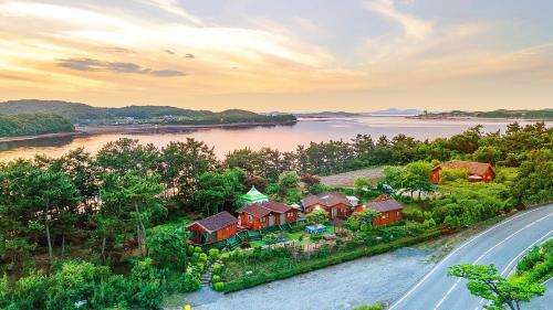 an aerial view of a house next to a river at Taean loghouse pension in Taean